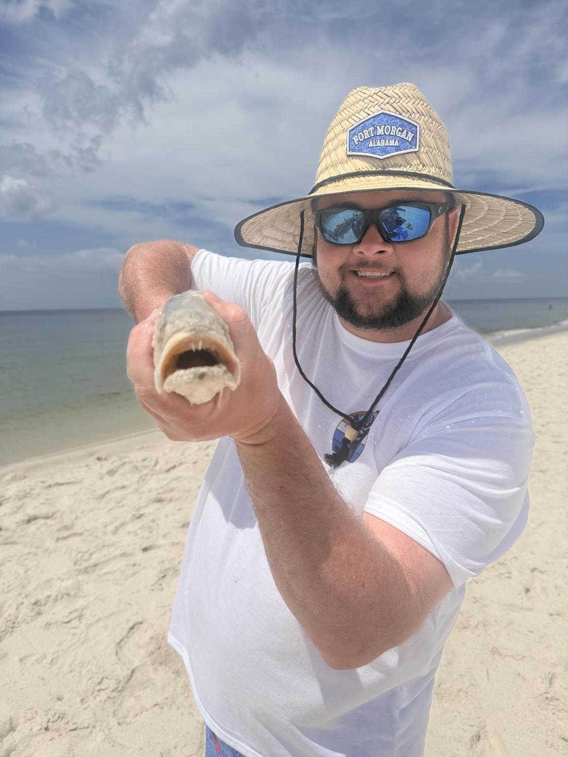 Angler showing a beach catch close to the camera